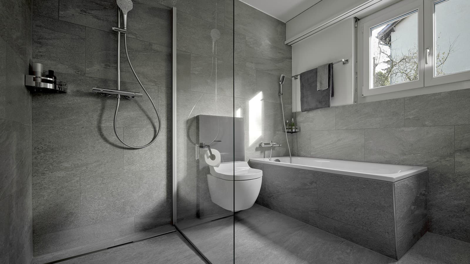 A shower toilet between a floor-standing shower and a bathtub A shower toilet between a floor-standing shower and a bathtub