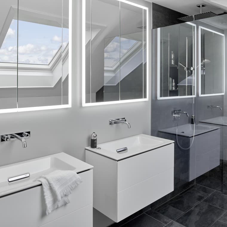 Bathroom under the roof with two washbasins and mirrors Bathroom under the roof with two washbasins and mirrors